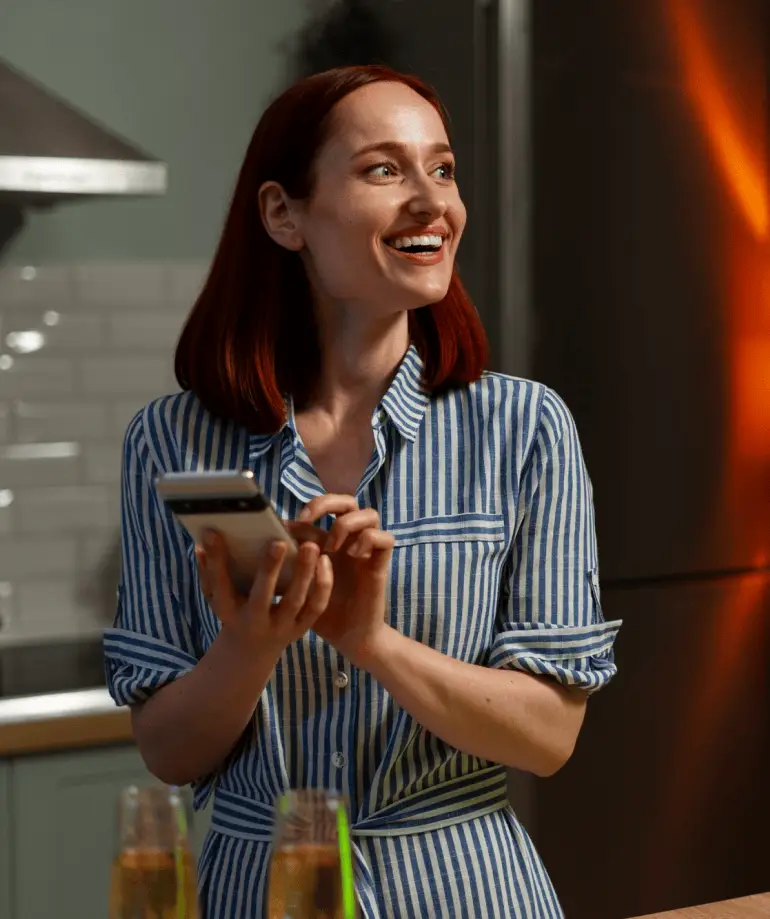 Smiling woman contacting Think Smart Security on her smartphone